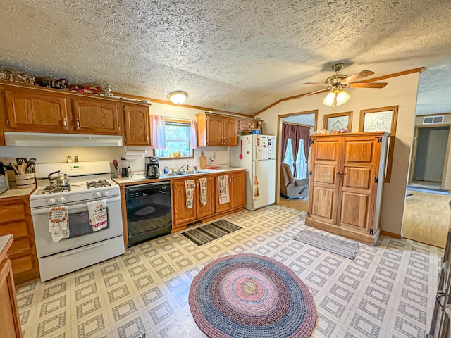 2314 Revolt Rd, Manistee, MI 49660 - kitchen with white appliances, under cabinet range hood, a ceiling fan, lofted ceiling, and light countertops