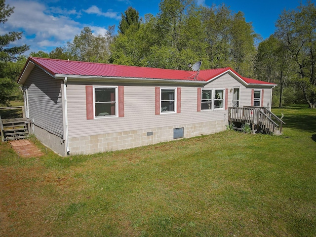 2314 Revolt Rd, Manistee, MI 49660 - view of front of property with metal roof, crawl space, and a front lawn