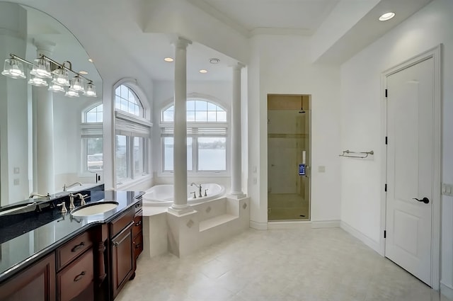 bathroom with separate shower and tub, ornate columns, and vanity