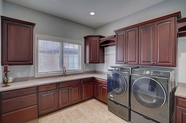 washroom with washer and clothes dryer, cabinets, and sink