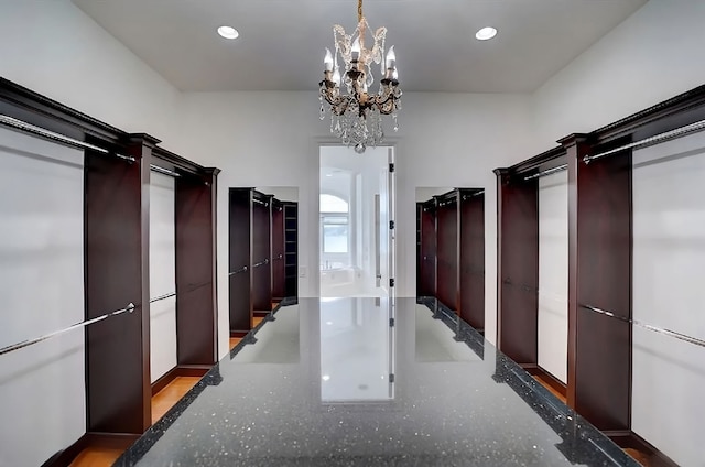 walk in closet featuring an inviting chandelier