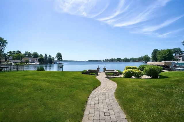 view of community featuring a yard and a water view