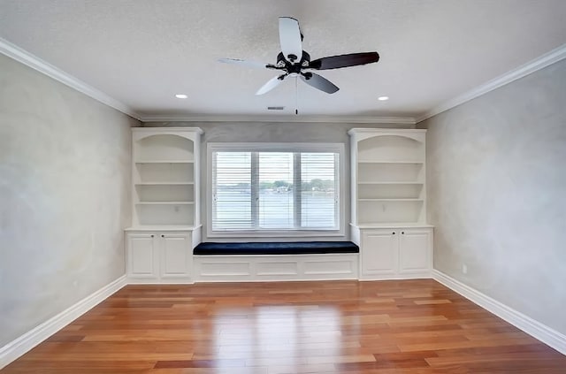 spare room featuring a textured ceiling, ceiling fan, crown molding, and light hardwood / wood-style flooring