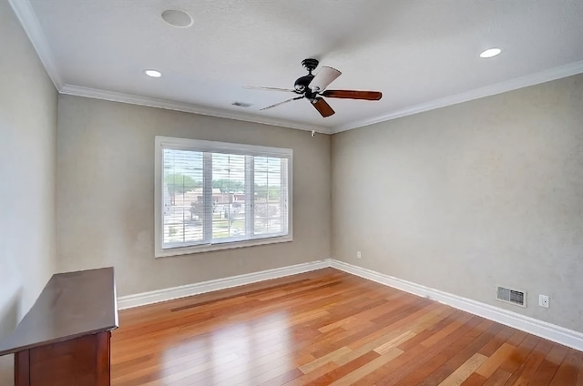 empty room with ceiling fan, light hardwood / wood-style flooring, and ornamental molding