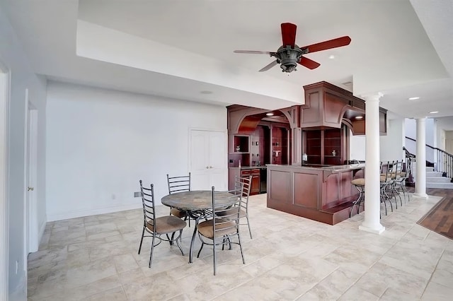 dining room featuring ornate columns and ceiling fan