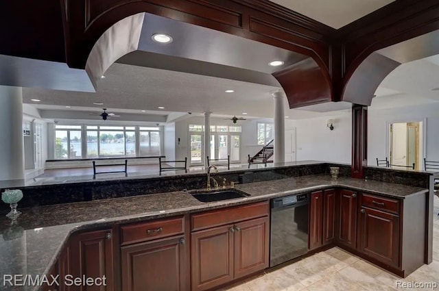 kitchen featuring ceiling fan, sink, black dishwasher, and dark stone counters