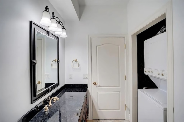 bathroom with vanity and stacked washer and dryer