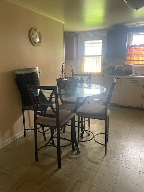 dining room with a healthy amount of sunlight and crown molding