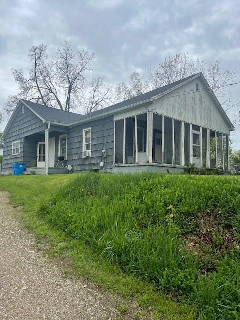 back of property with a sunroom