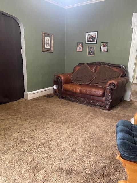 carpeted living room with ornamental molding