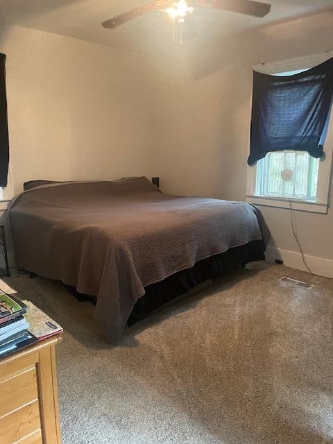 carpeted bedroom with ceiling fan