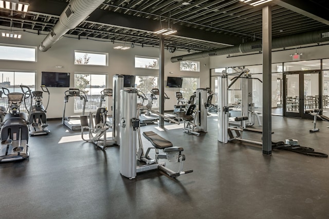 gym with a towering ceiling