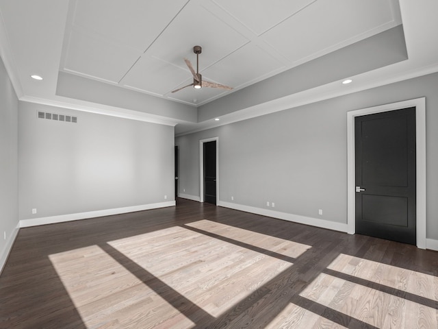 unfurnished room featuring ceiling fan, dark hardwood / wood-style floors, and ornamental molding