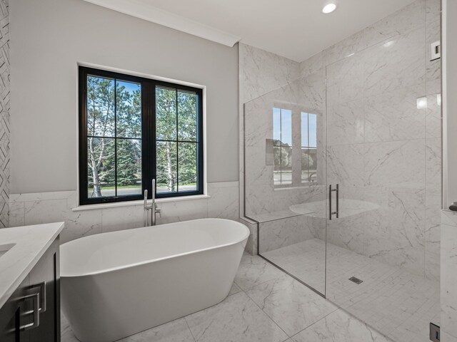 2605 Fairway, Rochester, MI 48306 - full bathroom featuring marble tiled flooring, tile walls, a freestanding bath, a marble finish shower, and a wainscoted wall