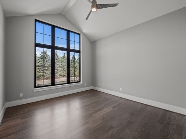 spare room featuring ceiling fan, a healthy amount of sunlight, dark hardwood / wood-style flooring, and lofted ceiling