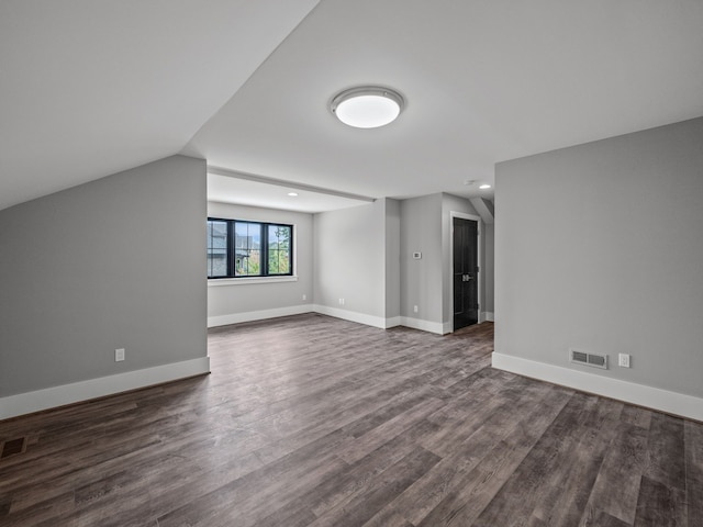 bonus room featuring dark hardwood / wood-style flooring and vaulted ceiling