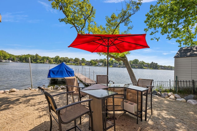 view of patio / terrace featuring a water view and a boat dock