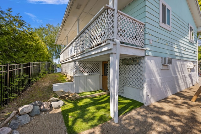 view of home's exterior with a wall unit AC