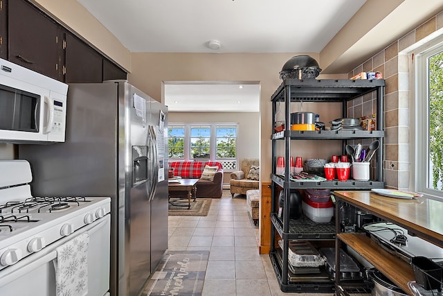 kitchen featuring white appliances and light tile patterned floors