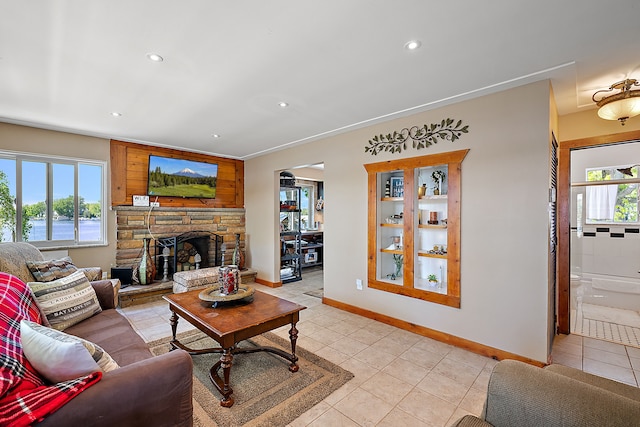 tiled living room featuring a healthy amount of sunlight and a fireplace