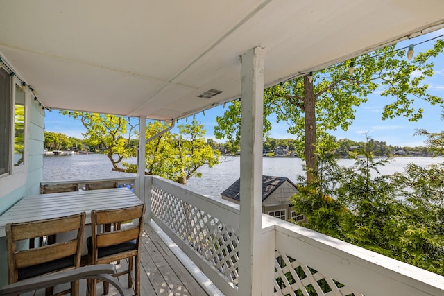 wooden deck featuring a water view