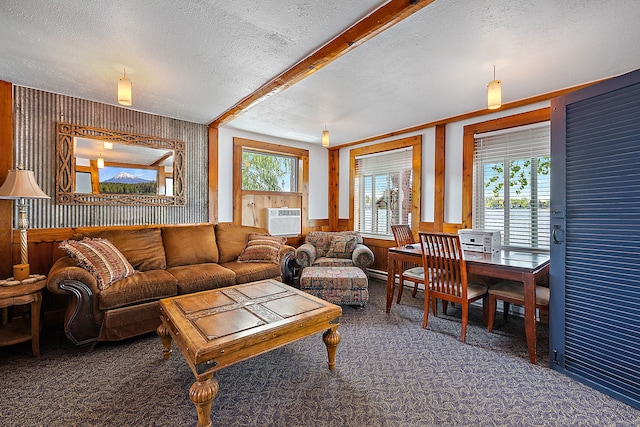 carpeted living room with a textured ceiling, a wall unit AC, and wood walls