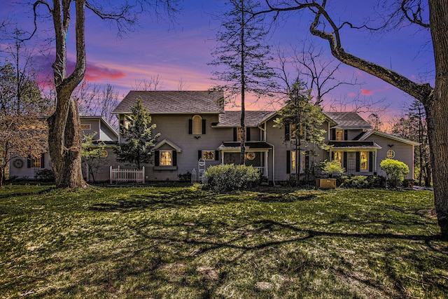 view of front of house featuring a lawn and a sunroom