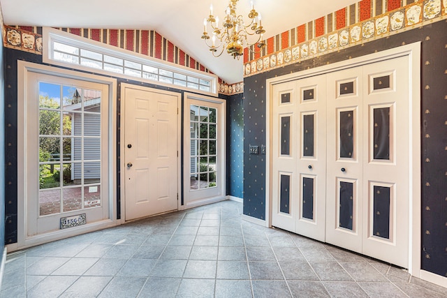 entryway featuring vaulted ceiling and an inviting chandelier