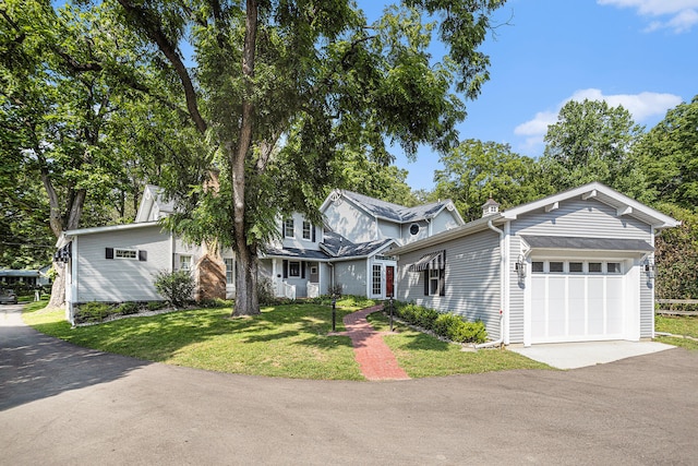 view of front facade with a front yard and a garage