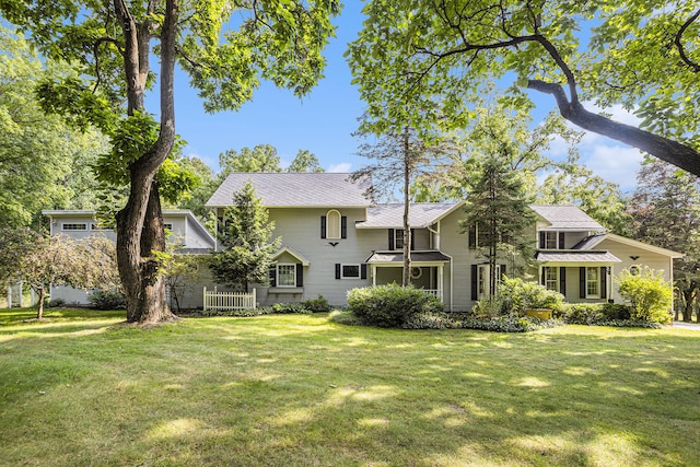 rear view of property featuring a yard