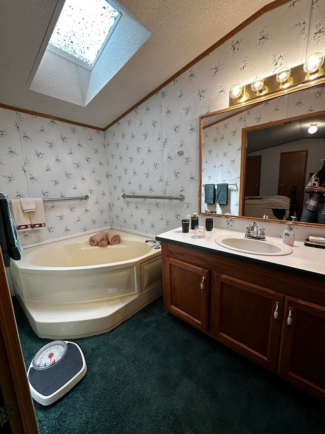 bathroom featuring a textured ceiling, vanity, lofted ceiling with skylight, and a bath