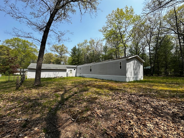 view of home's exterior with a yard