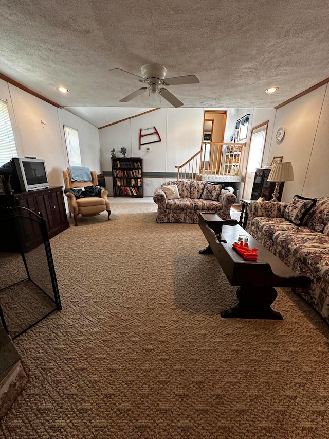 living room with carpet flooring, ceiling fan, a textured ceiling, and vaulted ceiling