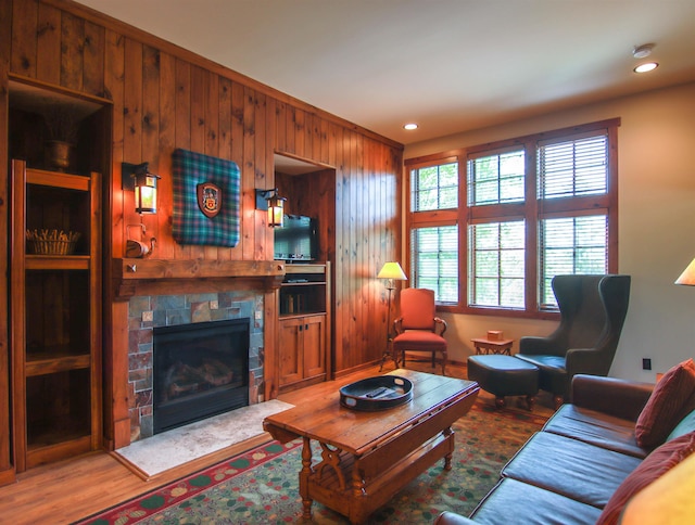 12328-UNIT335B Crystal Mountain Dr, Thompsonville, MI 49683 - living room with wooden walls, wood finished floors, a fireplace, and recessed lighting