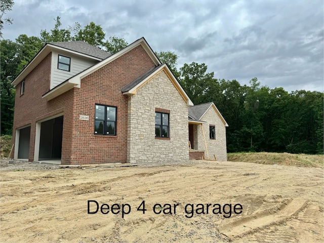 back of house featuring a garage