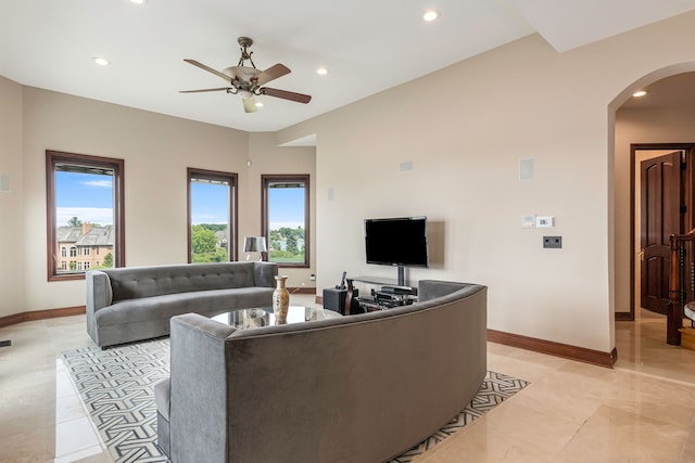 living room featuring ceiling fan, plenty of natural light, and light tile patterned flooring