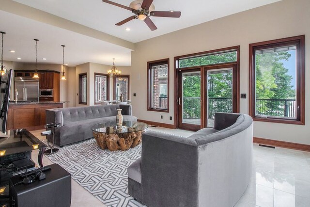 75 Chateaux Du Lac, Fenton, MI 48430 - living room featuring baseboards, a ceiling fan, a chandelier, recessed lighting, and light tile patterned flooring