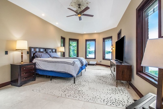 bedroom with multiple windows and ceiling fan