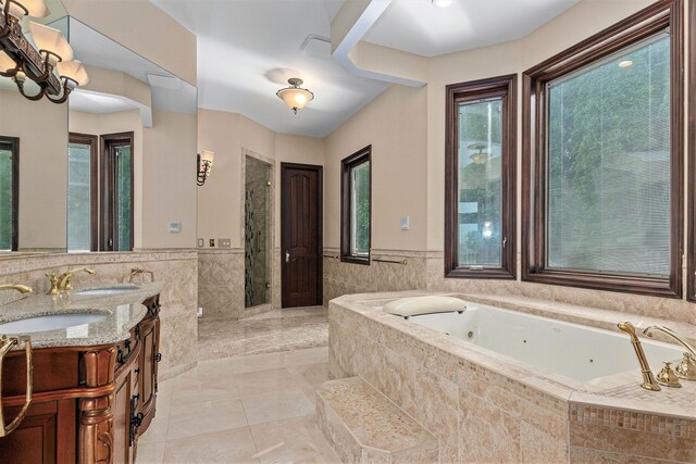 75 Chateaux Du Lac, Fenton, MI 48430 - full bath featuring tile walls, a jetted tub, a shower stall, double vanity, and wainscoting