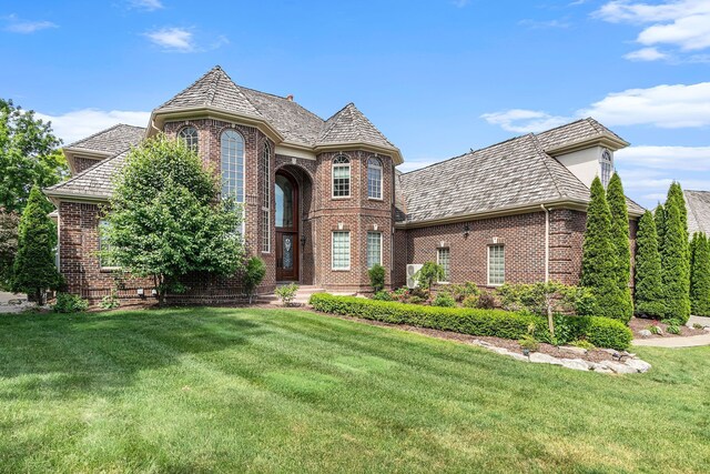 75 Chateaux Du Lac, Fenton, MI 48430 - view of front of home featuring brick siding, a front lawn, and a high end roof