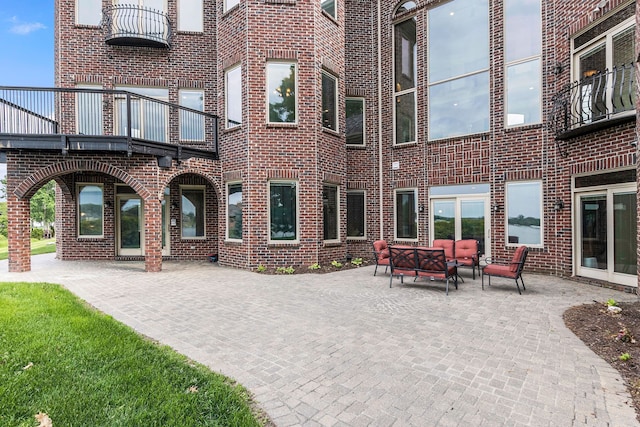 exterior space featuring outdoor lounge area and a balcony