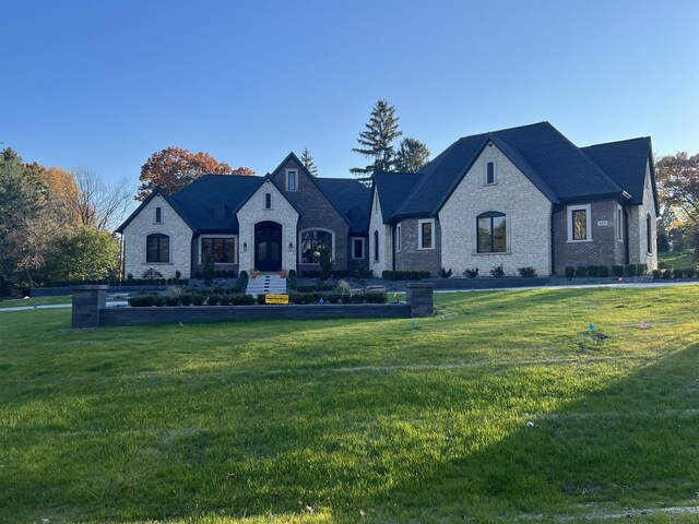 french country style house featuring a front lawn