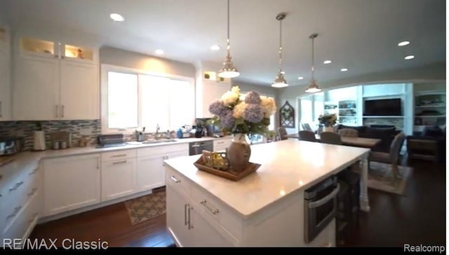 kitchen featuring white cabinetry, a center island, and pendant lighting