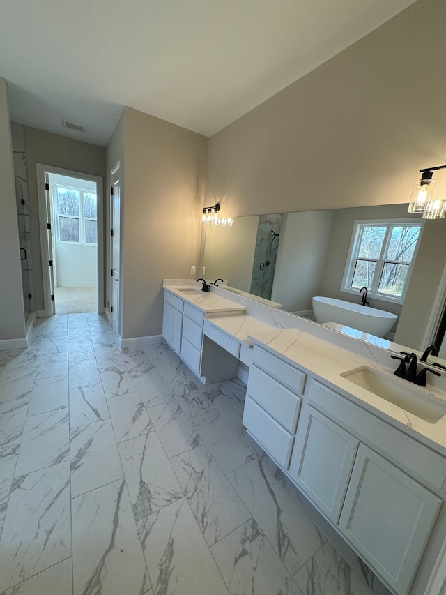 full bath featuring double vanity, marble finish floor, a sink, and a stall shower