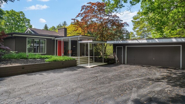 3586 E Huron River Dr, Ann Arbor, MI 48104 - view of front facade featuring a chimney and a garage