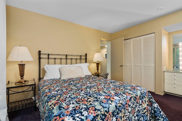 bedroom featuring a closet and dark colored carpet