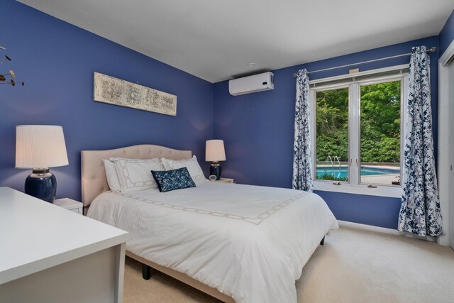 3586 E Huron River Dr, Ann Arbor, MI 48104 - carpeted bedroom featuring a wall mounted air conditioner and baseboards