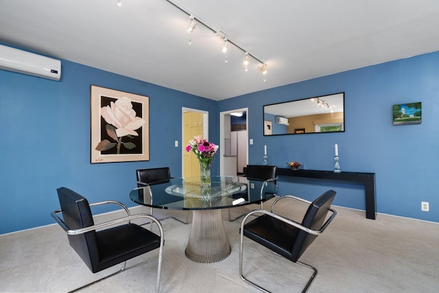 dining room featuring a wall mounted air conditioner, light carpet, and track lighting