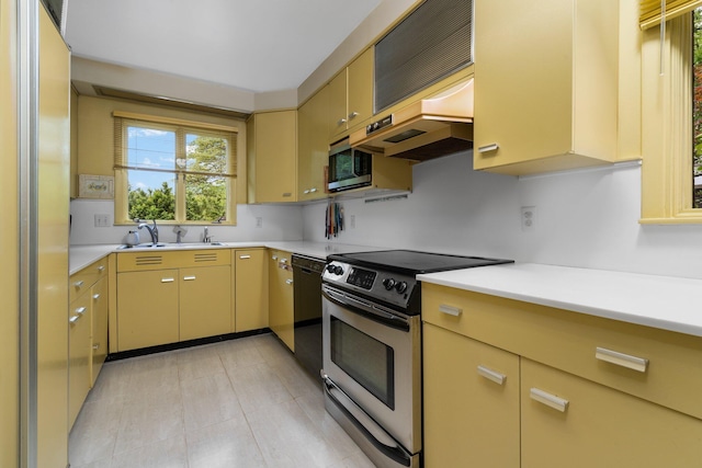 kitchen featuring stainless steel appliances, premium range hood, and sink