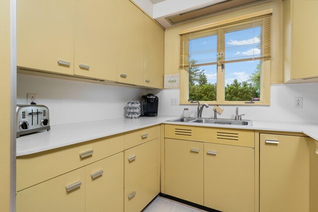 3586 E Huron River Dr, Ann Arbor, MI 48104 - kitchen with a sink, light countertops, and cream cabinets